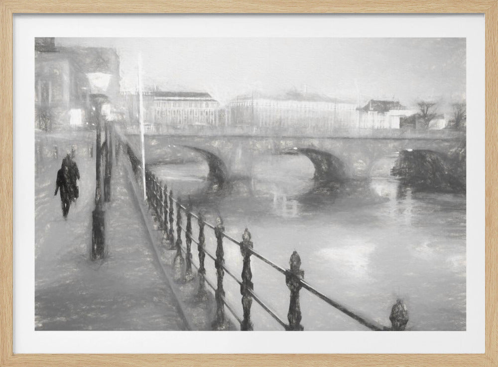 A framed, black and white impressionistic artwork of a city scene on a foggy or rainy day. In the foreground, a dark metal railing runs along a riverside walkway where a person in a dark coat is walking. An arched stone bridge crosses the river in the midground, with hazy buildings visible in the background, creating a moody and atmospheric scene. Wall Art