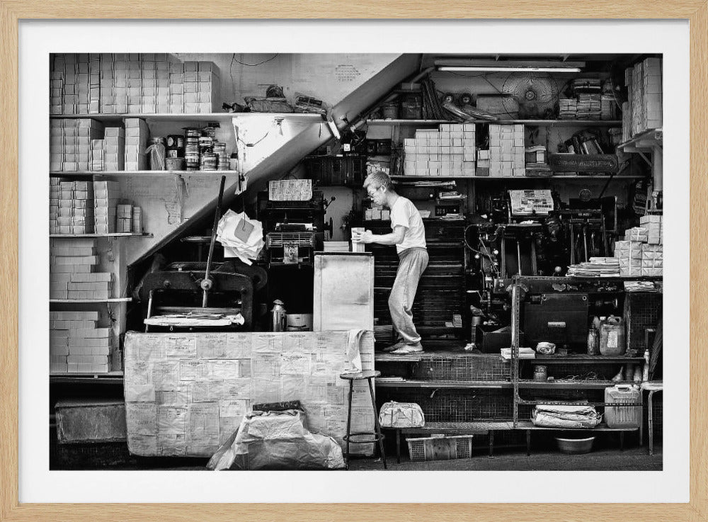 A vintage art print depicting a small, old-fashioned printing shop interior, showcasing antique machinery and a nostalgic atmosphere. Artwork