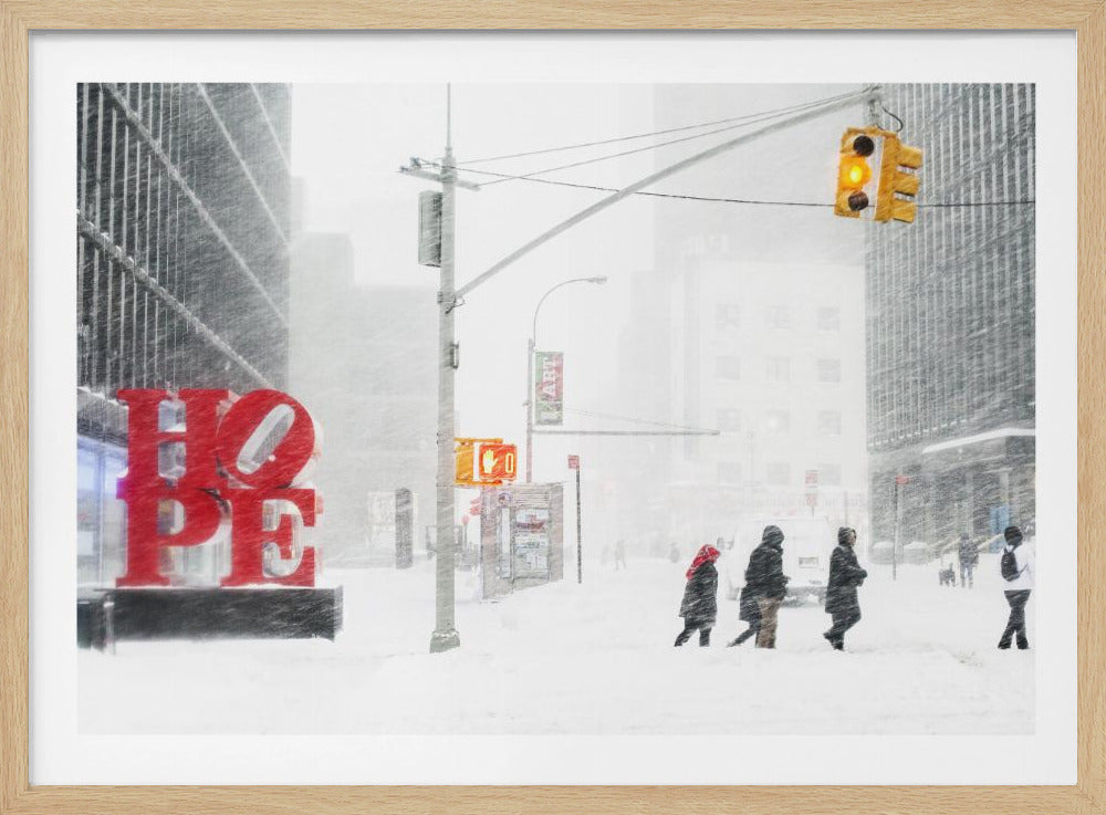 A photograph of a busy city street during a heavy snowstorm. In the foreground on the left, a large, bright red sculpture spells out the word 'HOPE', providing a stark contrast to the muted, white, and gray tones of the snowy scene. Pedestrians in winter coats are crossing the snow-covered street, and tall buildings are partially obscured by the falling snow in the background. Wall Art