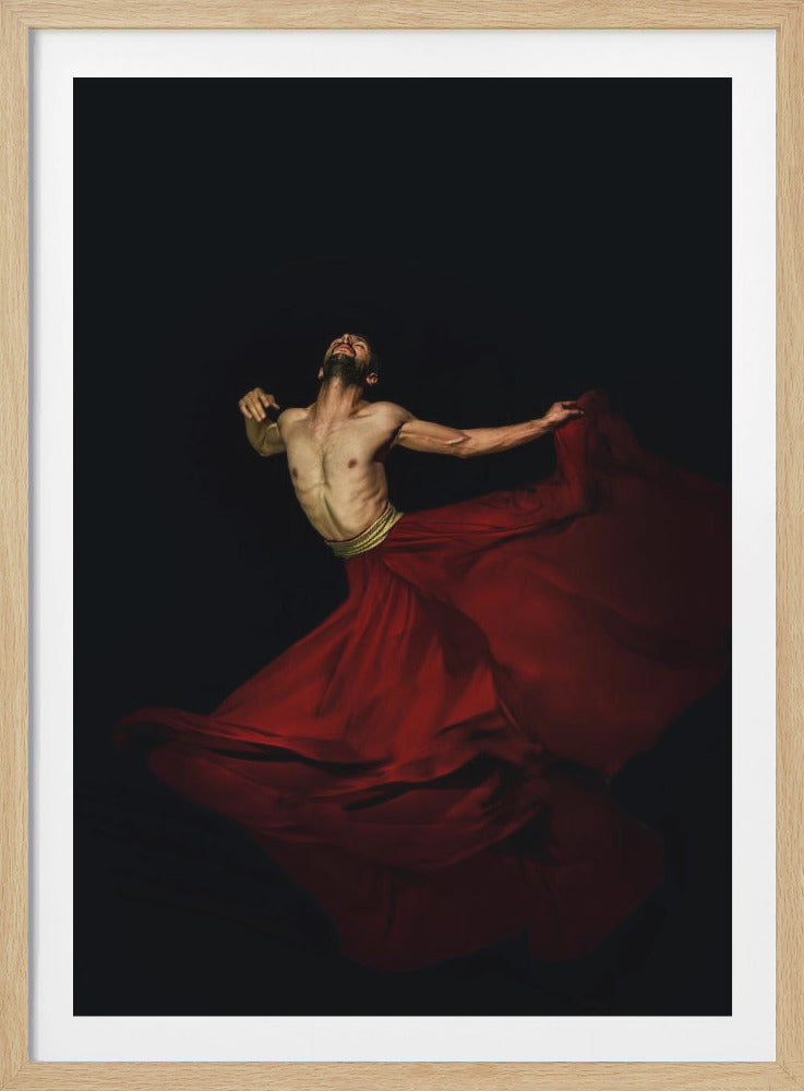 A dramatic portrait of a shirtless male dancer with a beard, his head tilted back in an expression of ecstasy against a solid black background. He wears a voluminous, flowing red skirt and a gold belt, with the fabric swirling around him in dynamic motion. Artwork
