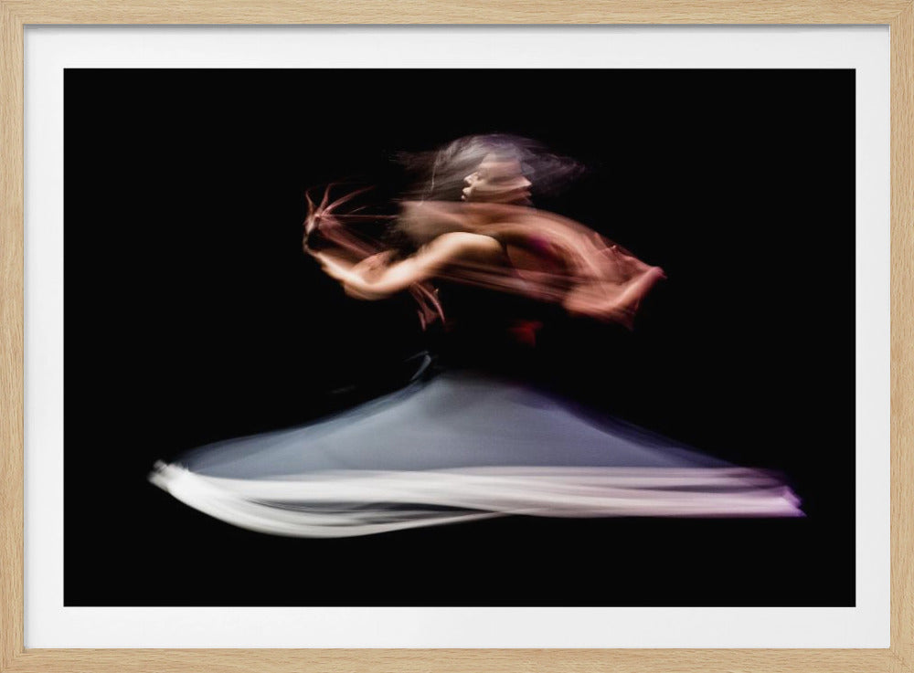 A long exposure photograph of a dancer against a black background, creating an abstract and ethereal image. The motion is captured in streaks of light, with the dancer's spinning white and purple skirt forming a wide blur below the blurred motion of her upper body and arms. Artwork