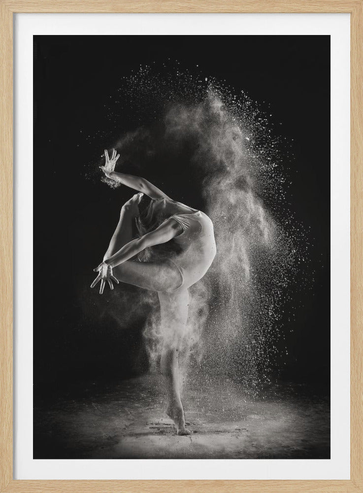 A dramatic black and white photograph of a female dancer in a leotard, frozen mid-motion. She arches her back gracefully, one leg extended high, as a cloud of white powder erupts around her against a stark black background, highlighting her dynamic movement. Print
