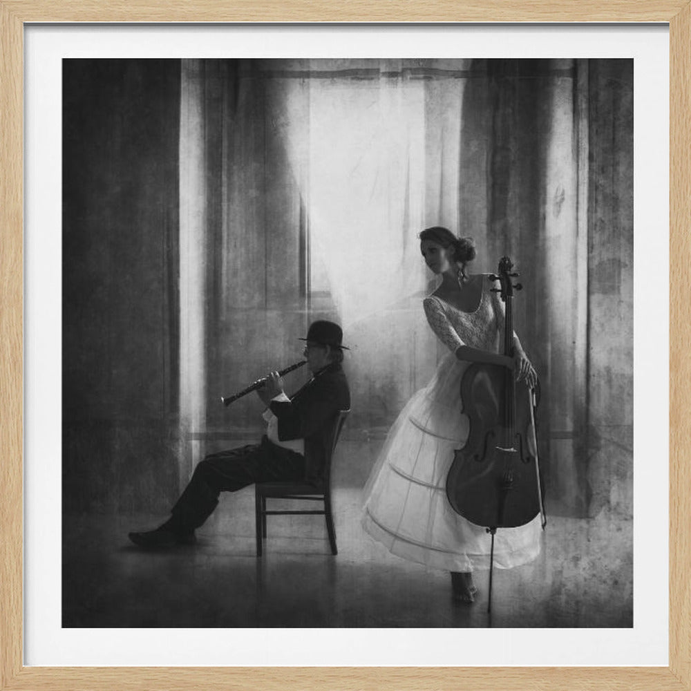 A framed, black and white artistic photograph of two musicians in a dimly lit room. A man in a dark suit and bowler hat sits playing a clarinet, while a woman in a long white vintage gown stands holding a cello, looking away. The scene is atmospheric with soft, hazy light. Print