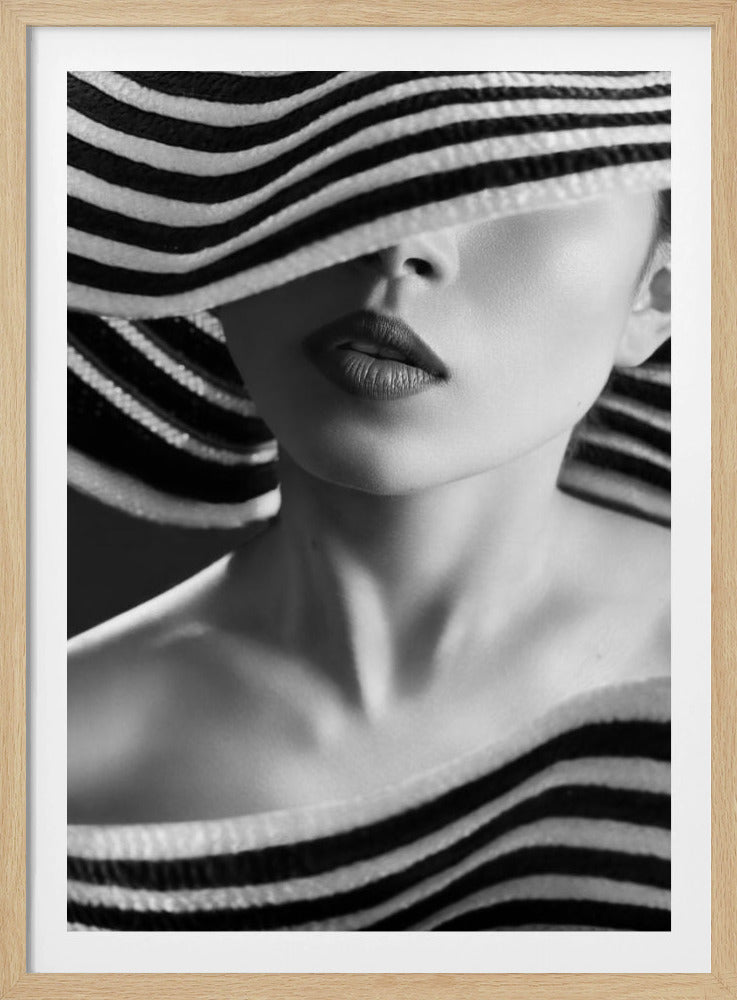 A mysterious black and white close-up portrait of a woman wearing a large, floppy hat with bold black and white stripes. The hat's brim covers her eyes, revealing only her nose, full lips, and chin, creating an elegant and enigmatic look. Decor