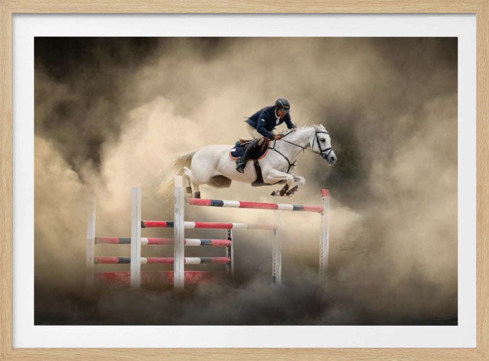 A dramatic action shot of a person in a blue jacket and helmet riding a powerful white horse as it leaps over a red and white striped obstacle, all enveloped in a swirling cloud of brown dust. Print