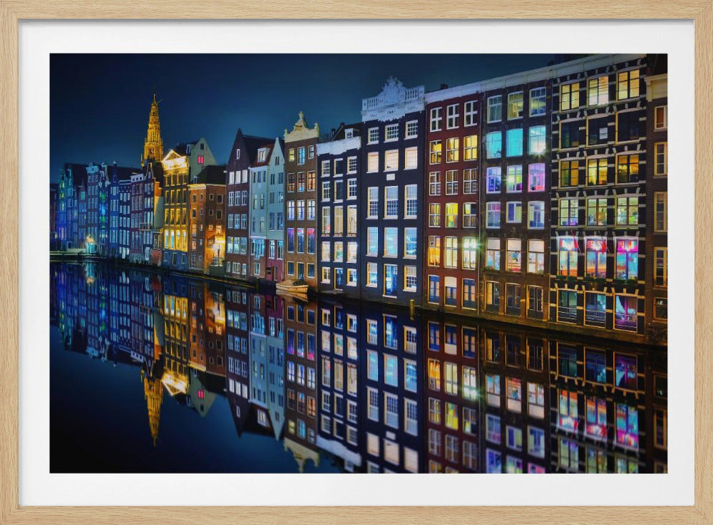 A vibrant nighttime cityscape of traditional Dutch canal houses in Amsterdam, their colorful, illuminated windows casting a perfect reflection on the still water below. Print