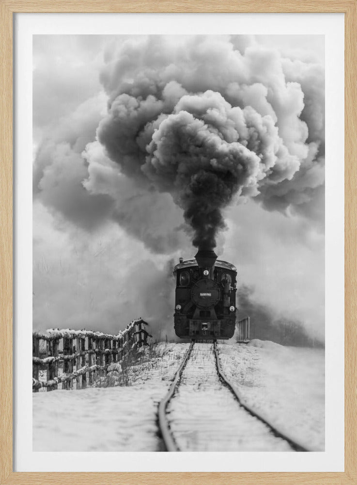 A dramatic black and white photograph of a vintage steam train on tracks in a snowy landscape, viewed from a low angle. A massive, powerful plume of dark smoke billows from the smokestack, filling the sky. Decor