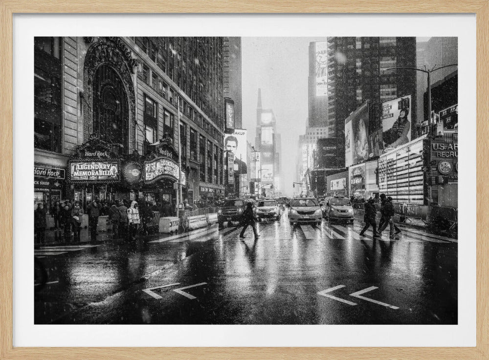 A moody black and white photograph of a snowy day in New York City's Times Square. The wet streets reflect the bright lights of the surrounding buildings and billboards as pedestrians cross the street and cars wait in traffic. Artwork