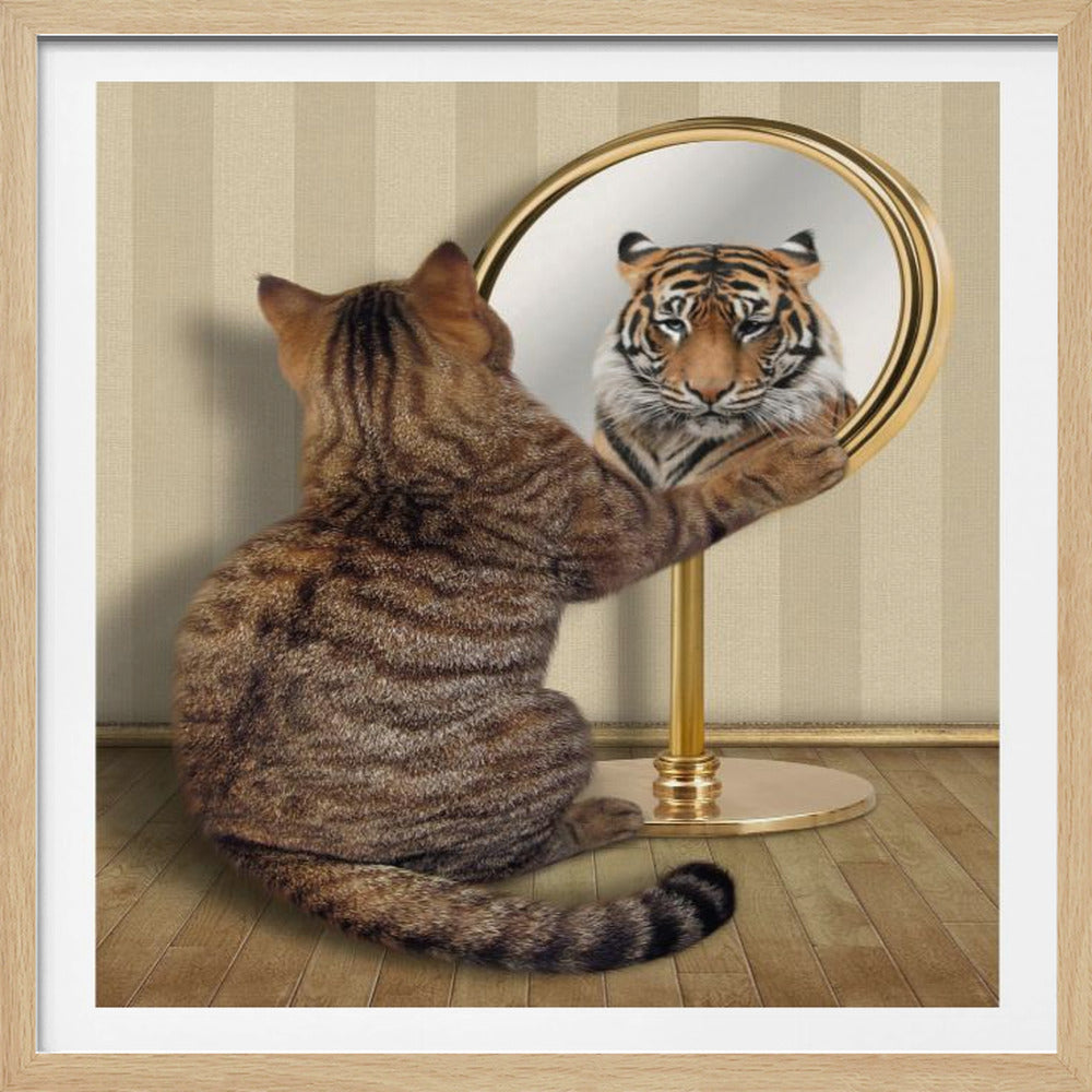 A brown tabby cat sits on a wooden floor, looking into a gold standing mirror. Instead of its own reflection, it sees the face of a large, powerful tiger looking back, symbolizing inner strength. Print
