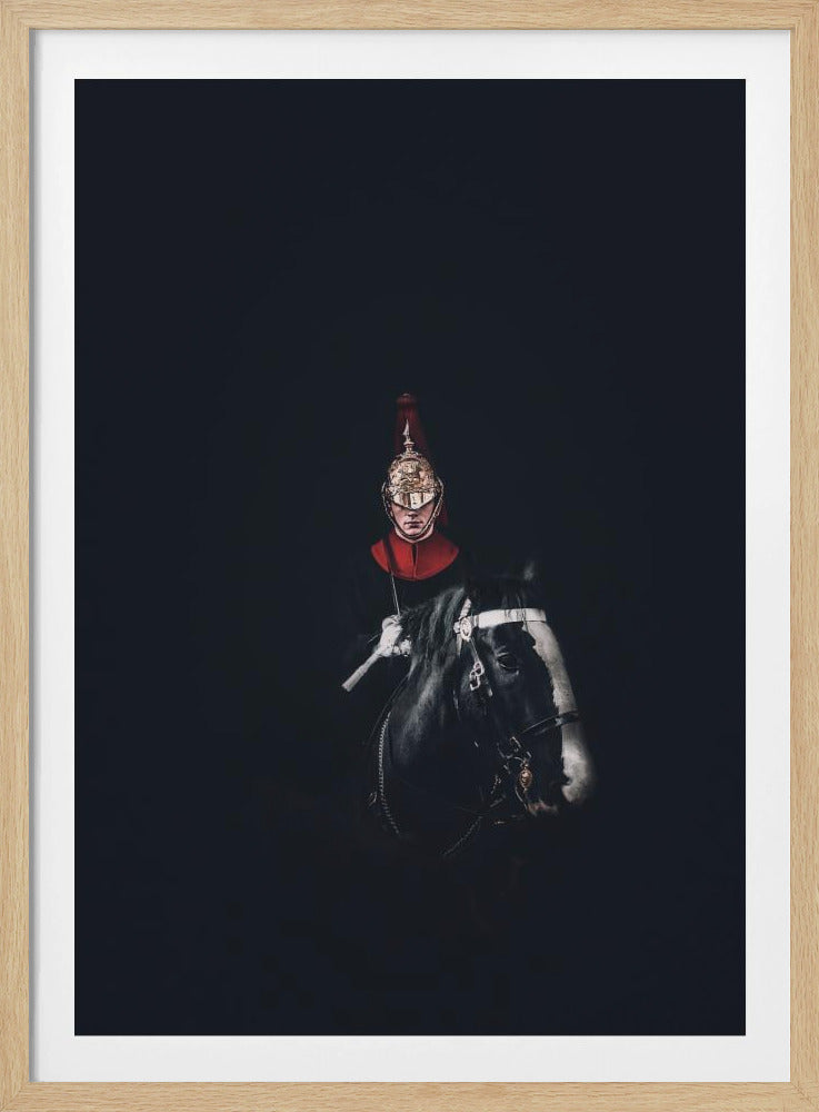 A dramatic portrait of a British Royal Guard on a black horse, emerging from a completely black background. The guard is wearing a traditional uniform with a red collar and a shiny gold helmet with a red plume. Poster