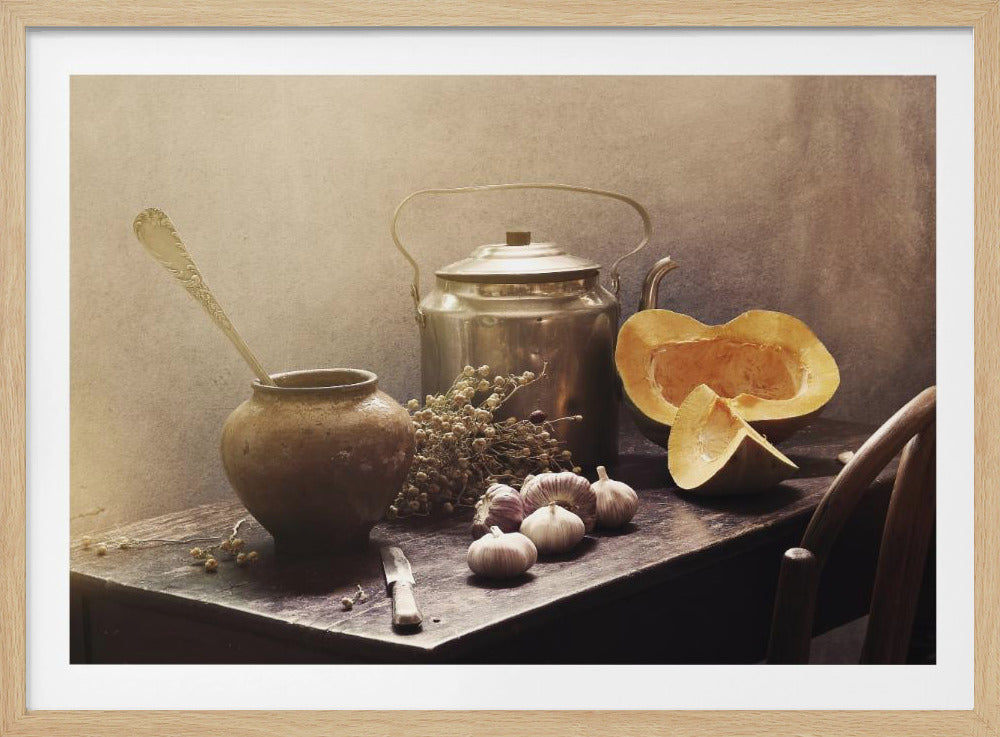 A rustic still life photograph with a vintage filter, featuring a collection of items on a dark wooden table. In the scene is a metal kettle, a brown earthenware pot with a spoon, a sliced pumpkin, several garlic bulbs, and dried flowers against a textured, neutral background. Poster