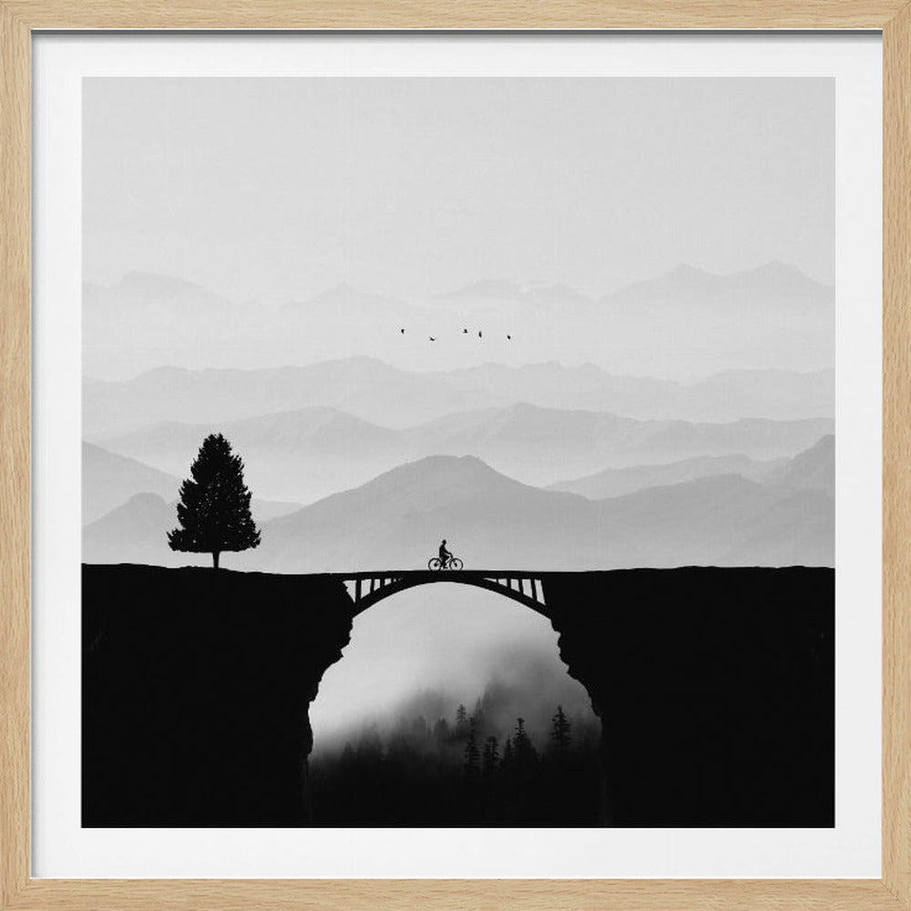 A minimalist black and white artwork featuring the silhouette of a cyclist crossing a high arched bridge between two cliffs. A lone tree stands on one cliff, while layers of misty mountains fill the background, creating a sense of depth and solitude. Poster