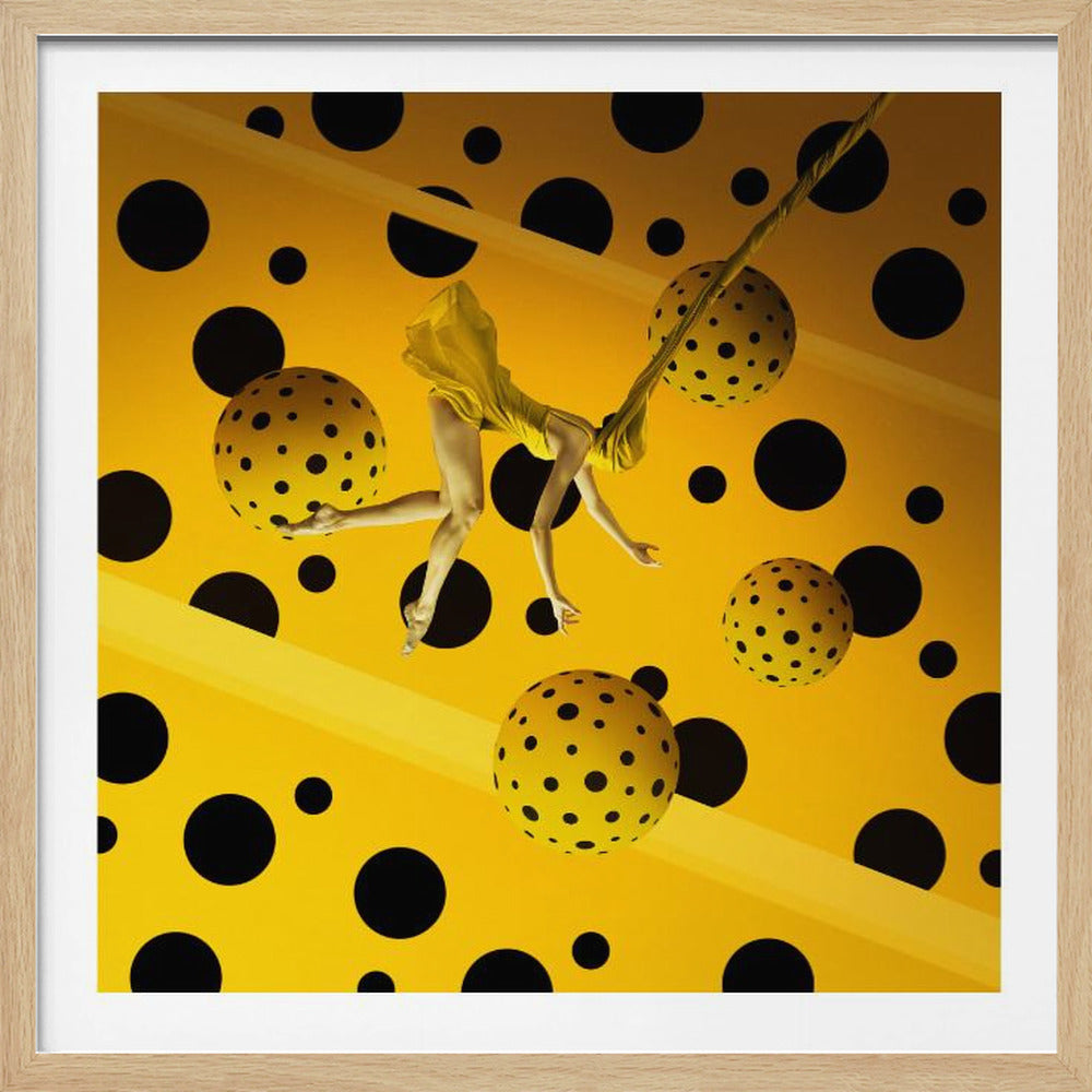 A surrealist artwork in a light wood frame, featuring a woman in a yellow dress floating horizontally against a vibrant yellow background covered in large black polka dots. She is surrounded by several floating yellow spheres that are also covered in black polka dots. Wall Art