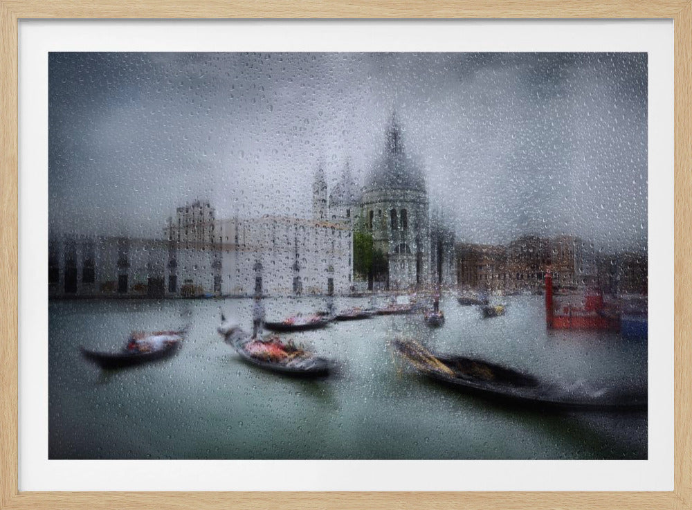 An impressionistic photograph of Venice on a rainy day, viewed through a window covered with raindrops. The Basilica di Santa Maria della Salute is visible in the background, blurred by the rain, while several gondolas with motion blur float on the teal water of the Grand Canal. Poster