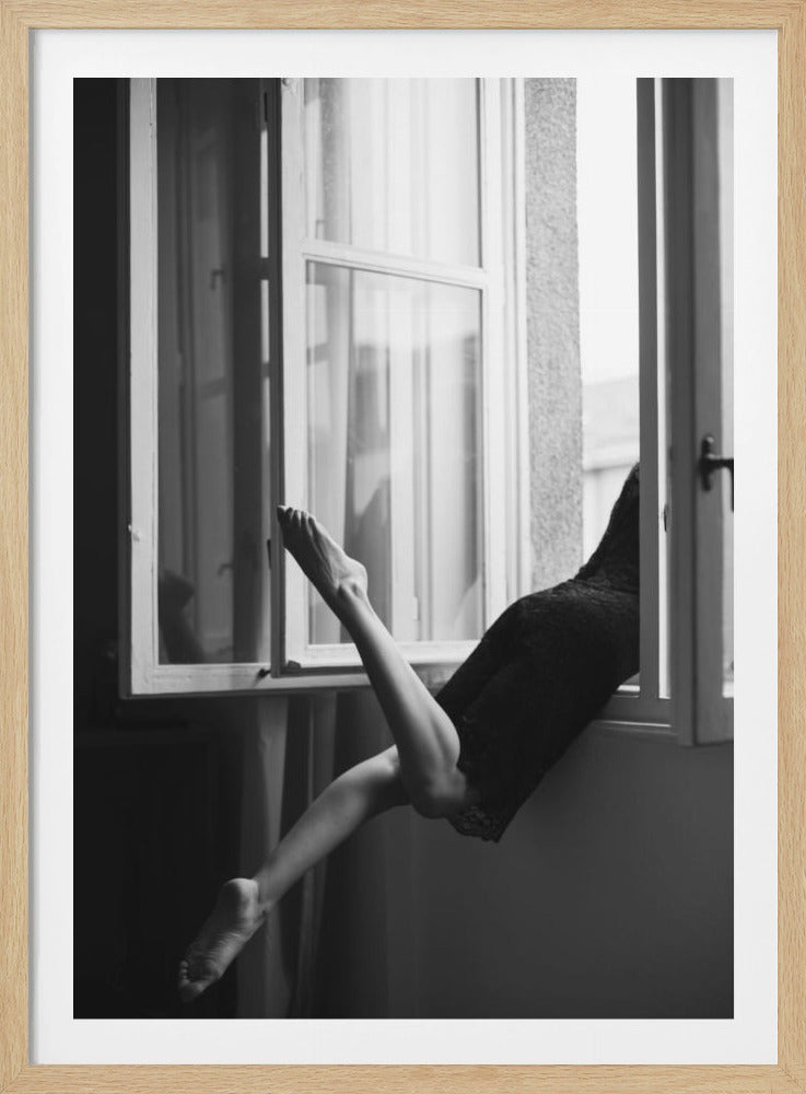 A black and white artistic photograph showing the lower half of a person's body positioned in an open window. Their legs are gracefully posed, one pointed up towards the window frame and the other dangling down, creating a silhouette against the light from outside. Poster