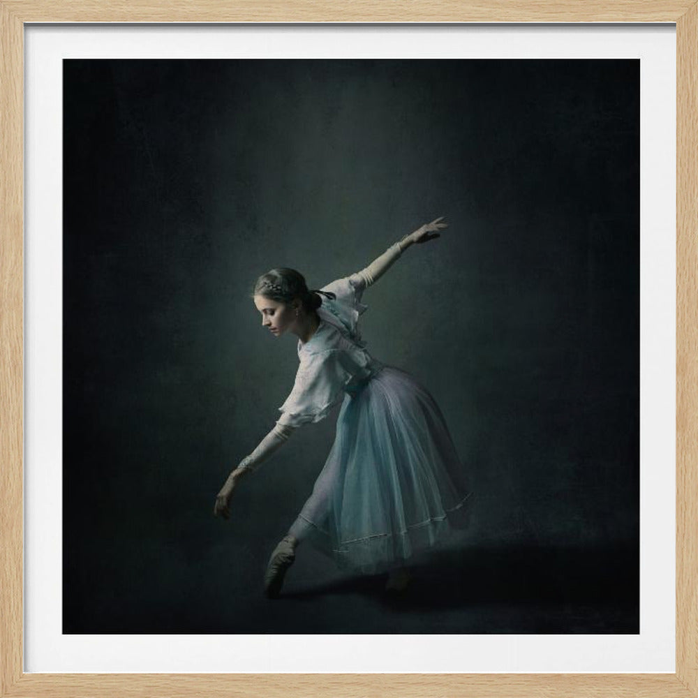A fine art portrait of a graceful ballerina mid-pose, wearing a long, light blue tutu and a white bodice. She is illuminated by dramatic side lighting against a dark, moody background, all enclosed in a simple light wood frame. Poster