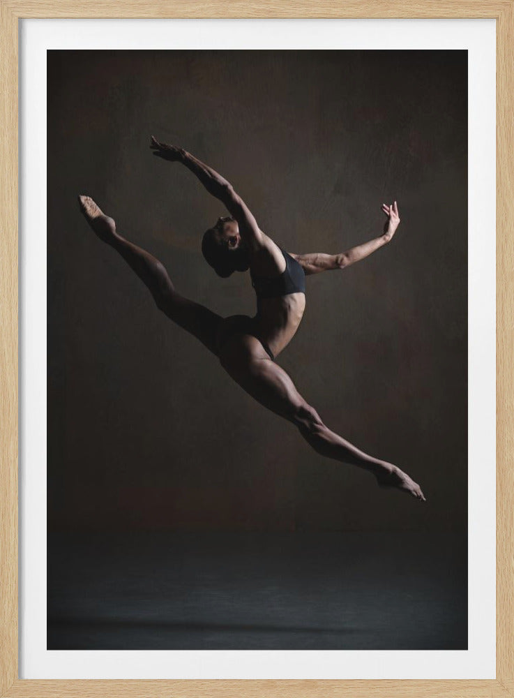 A dramatic, low-key studio photograph of a muscular female dancer captured mid-leap. She is in a full split, arching her back with her arms extended gracefully. The lighting accentuates her toned physique against a dark, textured brown background. Poster