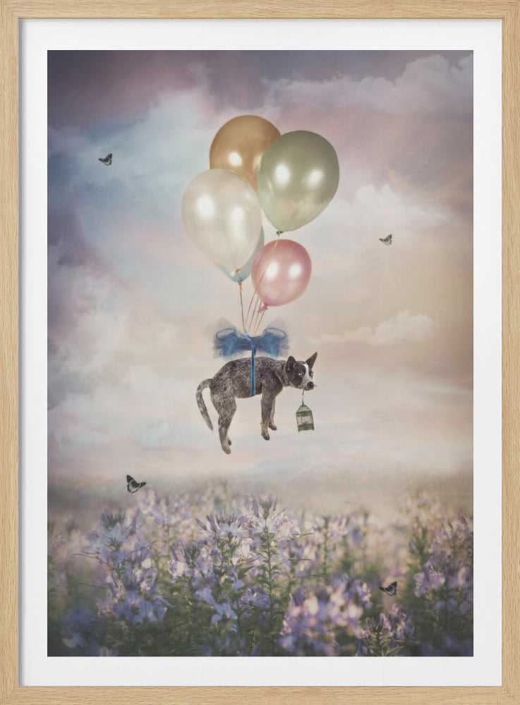 A whimsical framed artwork depicting a gray dog floating in a dreamy, pastel-colored sky, lifted by a bunch of four balloons tied to its back with a blue bow. The dog holds a small birdcage in its mouth as it flies over a field of purple wildflowers with butterflies fluttering around. Print