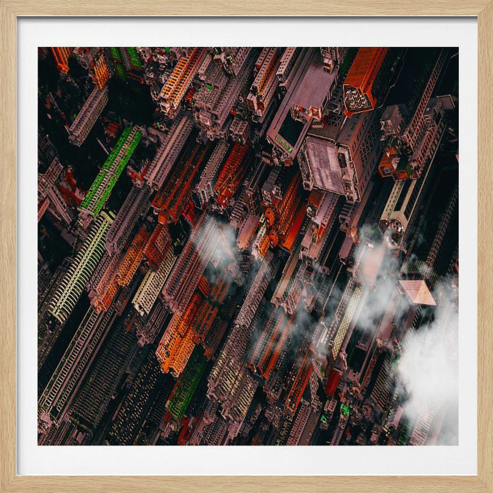 A dramatic, high-angle aerial photograph looking straight down into a super-dense, futuristic cityscape with towering skyscrapers packed together, featuring pops of orange and green among the dark buildings. Wisps of clouds float between the towers, and the image is presented in a light wood frame. Print