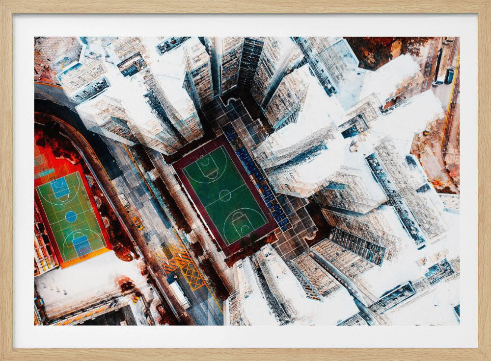 A dizzying top-down aerial view of a dense city, where stark white skyscrapers tower over two vibrant basketball courts, one green and the other multicolored. The abstract, high-contrast style highlights the geometric patterns of urban life, all enclosed within a silver frame. Poster