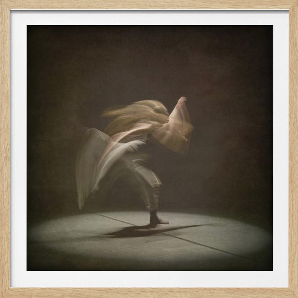 A framed, long-exposure photograph captures a dancer in motion under a spotlight. The dancer's blonde hair and limbs are blurred, creating an abstract and dynamic effect against a dark, moody background. Print