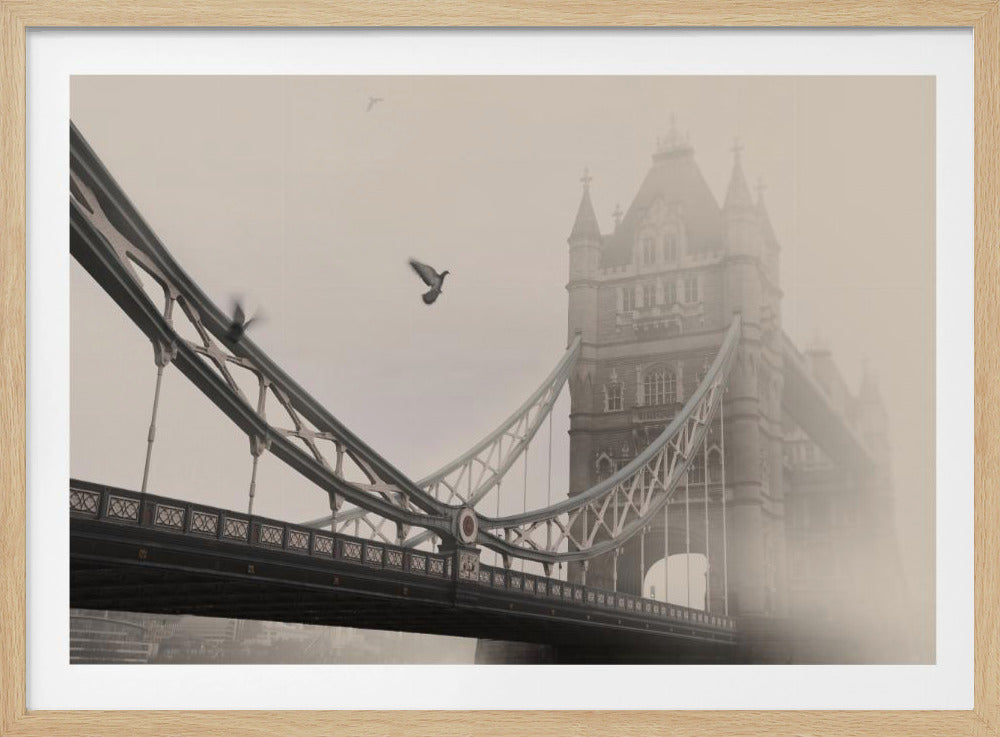 A sepia-toned, framed photograph of the Tower Bridge in London on a foggy day. The bridge's towers are partially obscured by the thick mist, and several pigeons are seen flying in the foreground near the suspension cables, adding a sense of movement to the atmospheric scene. Poster
