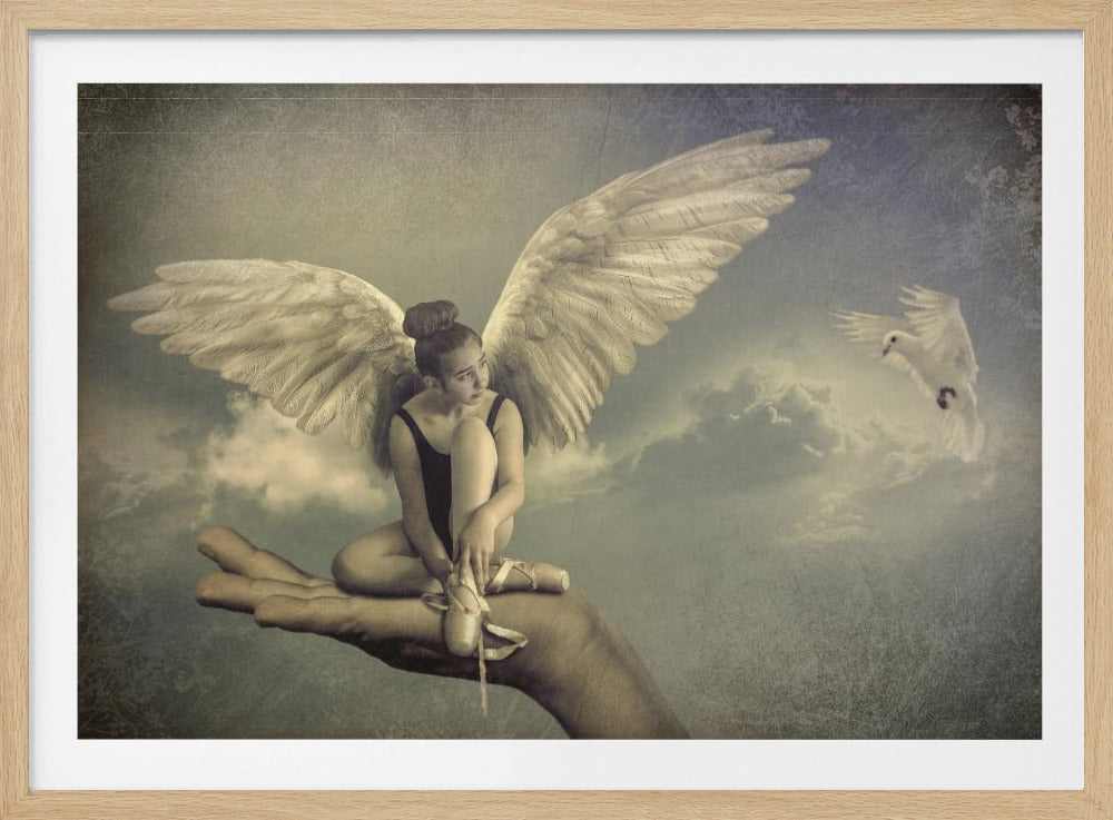 A surreal, vintage-style artwork depicting a young ballerina with large white angel wings sitting in the palm of a giant hand floating in a cloudy sky. She is dressed in a dark leotard and is tying her pointe shoes. A white dove flies in the distance. The image is presented in a silver frame. Print