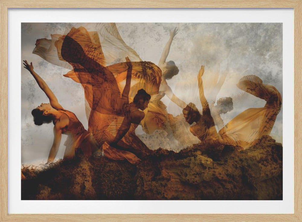 A framed piece of art featuring a multiple exposure photograph of several female dancers in flowing orange gowns, creating an ethereal sense of movement against a textured gray background and a rocky foreground. Decor