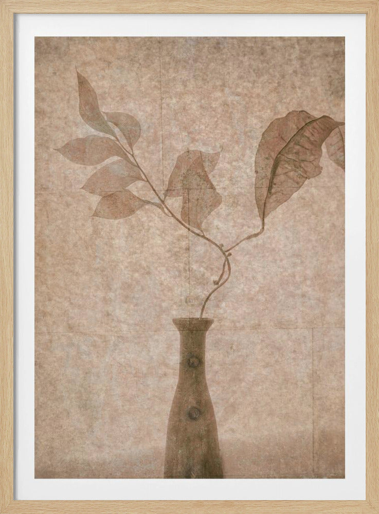 A vintage-style still life artwork featuring delicate, semi-transparent brown leaves on a thin branch inside a rustic brown vase, all set against a textured beige background and enclosed in a thin black frame. Decor