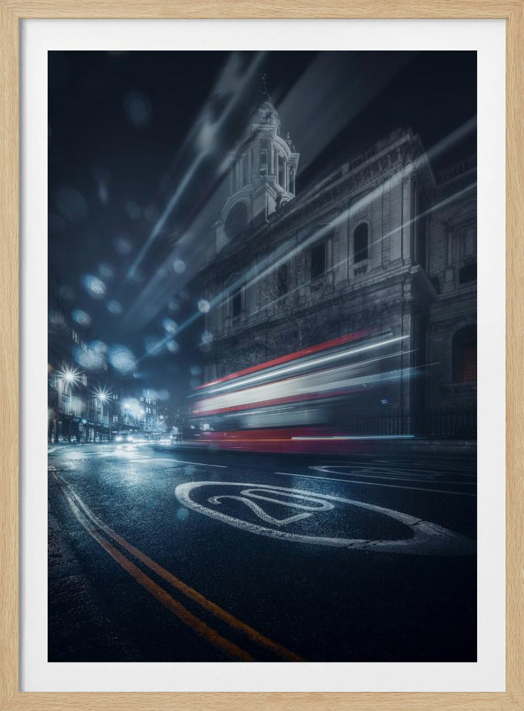 A dramatic long-exposure photograph of a wet city street at night, with the red light trails of a passing double-decker bus blurring past a grand, historic building. The foreground shows a '20' speed limit marking on the glistening asphalt. Poster