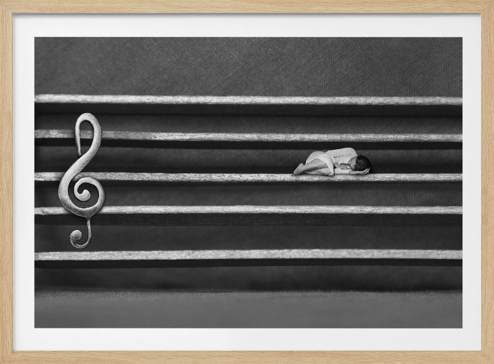 A surreal black and white artwork depicting a musical staff where a tiny person is sleeping on one of the lines, taking the place of a musical note, with a large treble clef on the left. Print