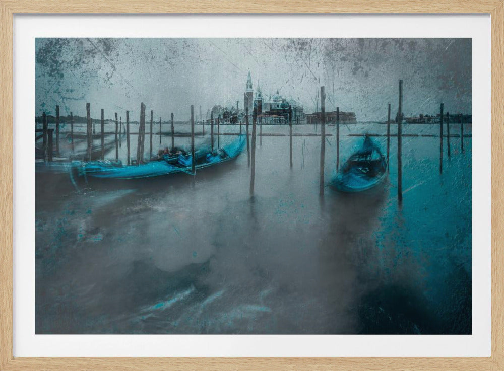 A moody, artistic photograph of Venice in a silver frame. Two bright blue gondolas are moored to wooden posts in the foreground, floating on misty, dark blue water. In the background, the iconic San Giorgio Maggiore church is visible across the water. The image has a distressed, textured overlay and a cool, blue-gray color palette. Decor