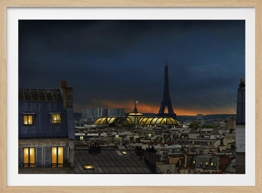 A framed view of the Paris skyline at dusk, with the silhouetted Eiffel Tower against a deep blue and orange sunset sky, viewed over the city's dark rooftops and the illuminated Grand Palais. Print