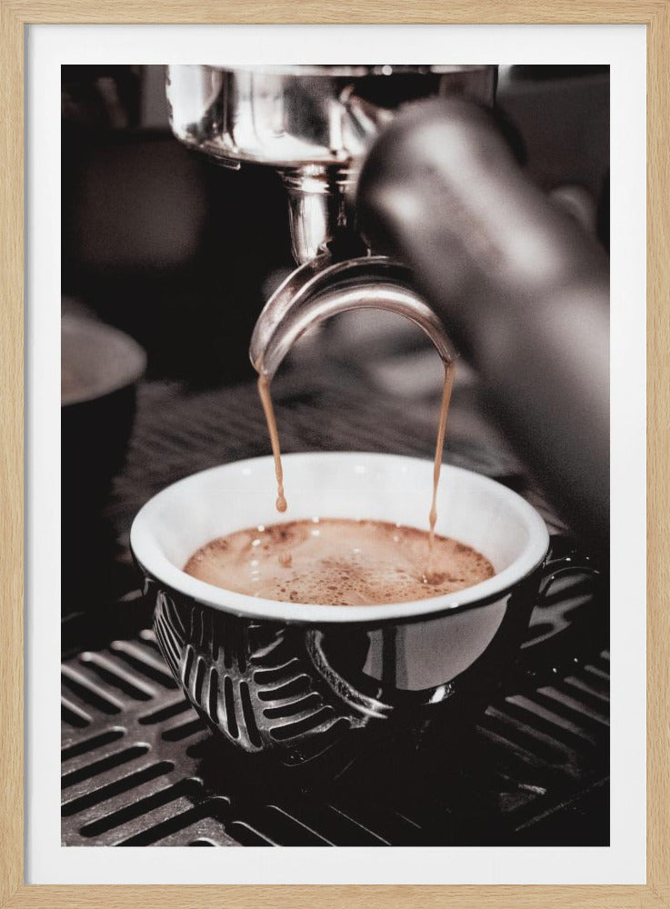 A close-up, desaturated photograph of an espresso machine pouring two streams of rich brown coffee from a chrome portafilter into an ornate black and white cup. Poster