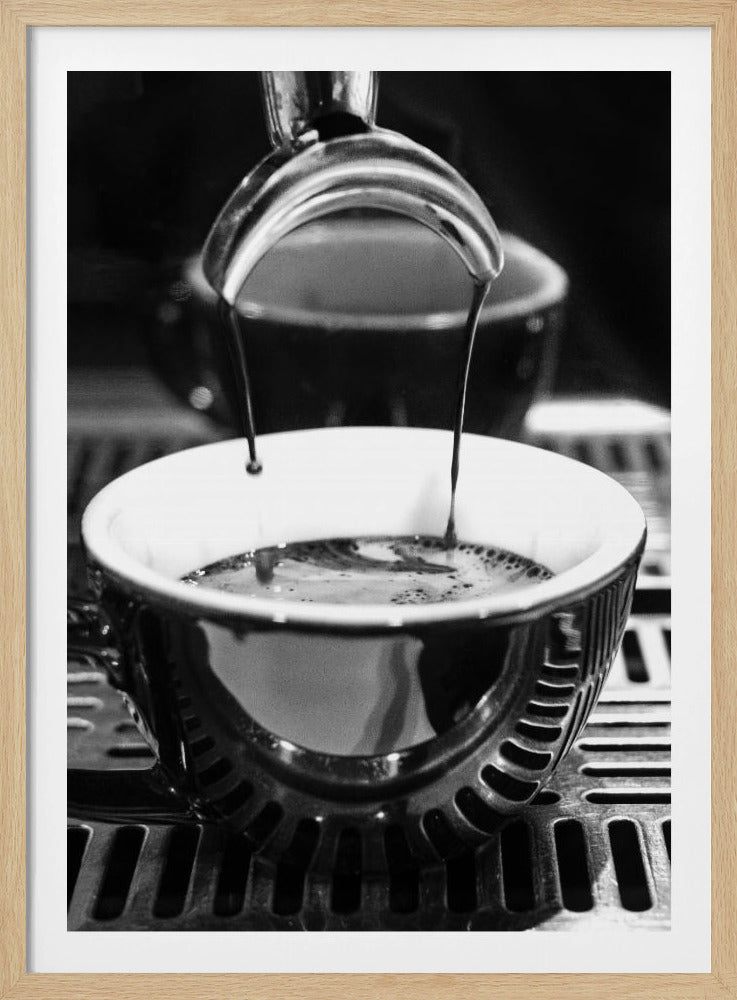 A close-up, black and white artistic photograph capturing the moment two streams of dark espresso pour from a portafilter into a waiting cup on a coffee machine's drip tray. Wall Art