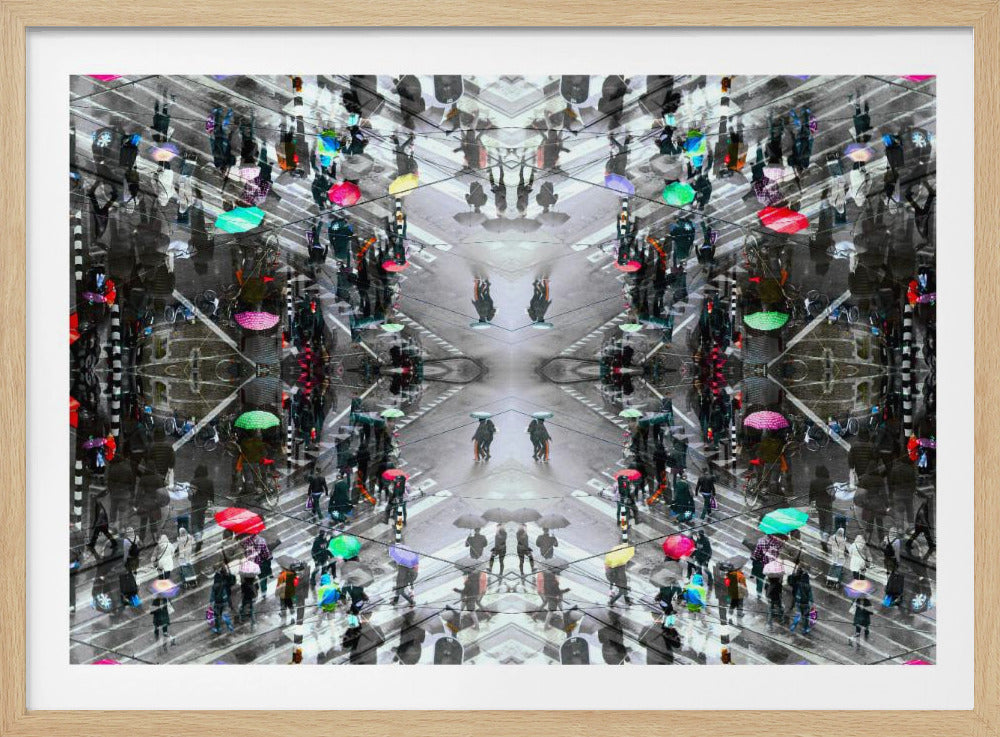 A symmetrical, kaleidoscopic abstract artwork created from an aerial view of a rainy city intersection. The mostly black and white image features pops of vibrant color from numerous umbrellas held by pedestrians crossing the street, all framed in a textured silver border. Artwork
