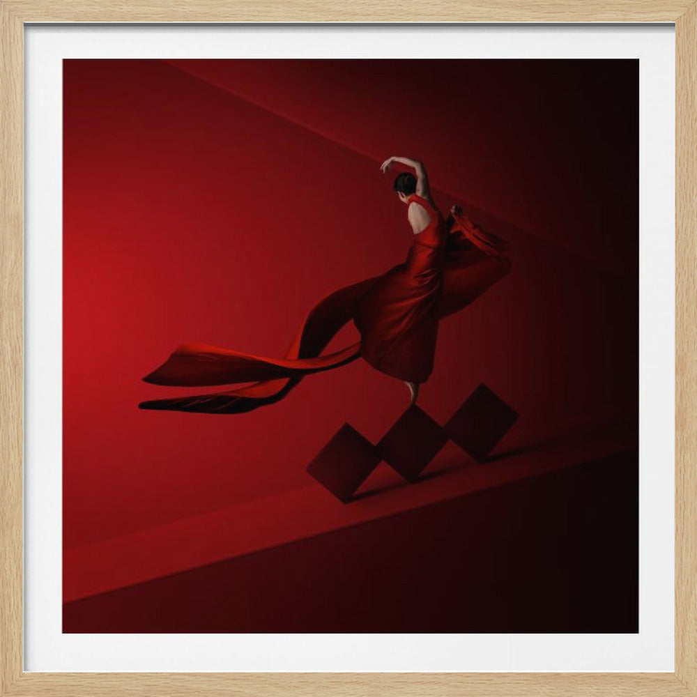 A surreal photograph of a female dancer in a flowing red gown, balancing gracefully on a series of red cubes against a dramatic, monochromatic red backdrop. Print