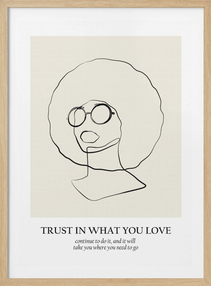 A minimalist art print in a black frame featuring a continuous black line drawing of a person with a large afro and round glasses on a beige background. Below the image is the text 'TRUST IN WHAT YOU LOVE' and in smaller font, 'continue to do it, and it will take you where you need to go'. Decor