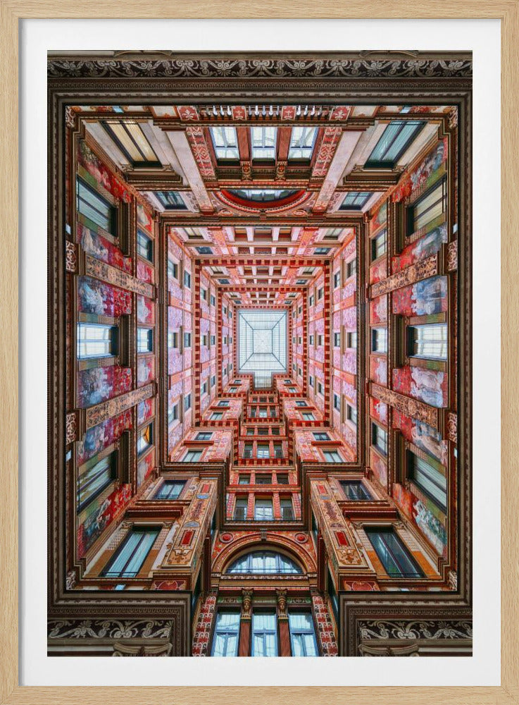 A symmetrical, worm's-eye view looking up through the center of an ornate, multi-story courtyard. The red and gold walls are covered in intricate details and frescoes, receding into the distance towards a square glass skylight. The entire artwork is presented within a decorative dark brown frame. Artwork