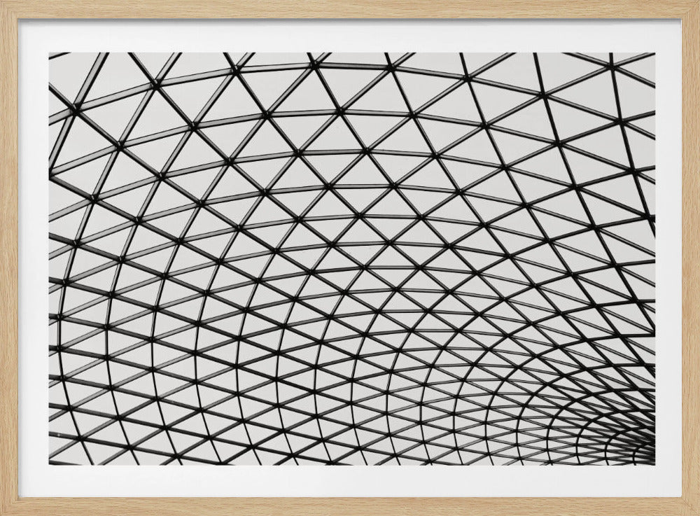 A framed, black and white photograph of a modern architectural dome ceiling. The image is a close-up, looking up at the intricate metal framework that creates a repeating pattern of triangles against the bright glass panels. Poster