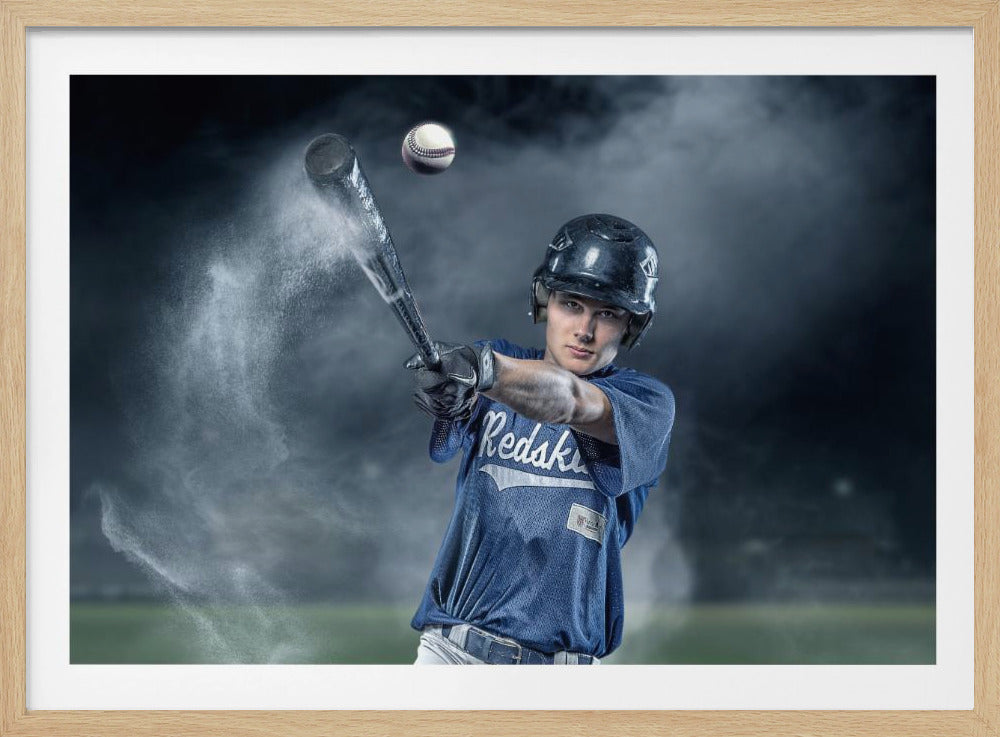 A dramatic, framed portrait of a young baseball player in a blue jersey and helmet, captured in the moment of hitting a baseball, with a cloud of dust exploding from the bat against a dark, smoky background. Poster