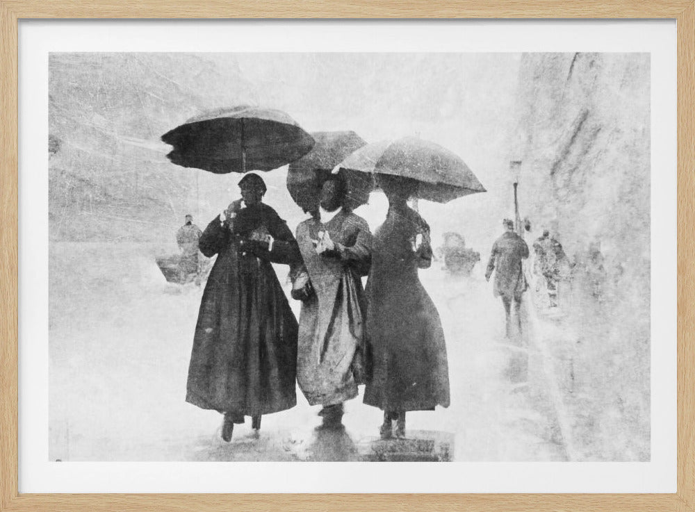 A vintage black and white photograph in a silver frame, depicting three people in long dark coats walking together under umbrellas during a heavy snow or rain storm on a city street. The image has a grainy, textured quality, giving it an old-fashioned, artistic feel. Poster