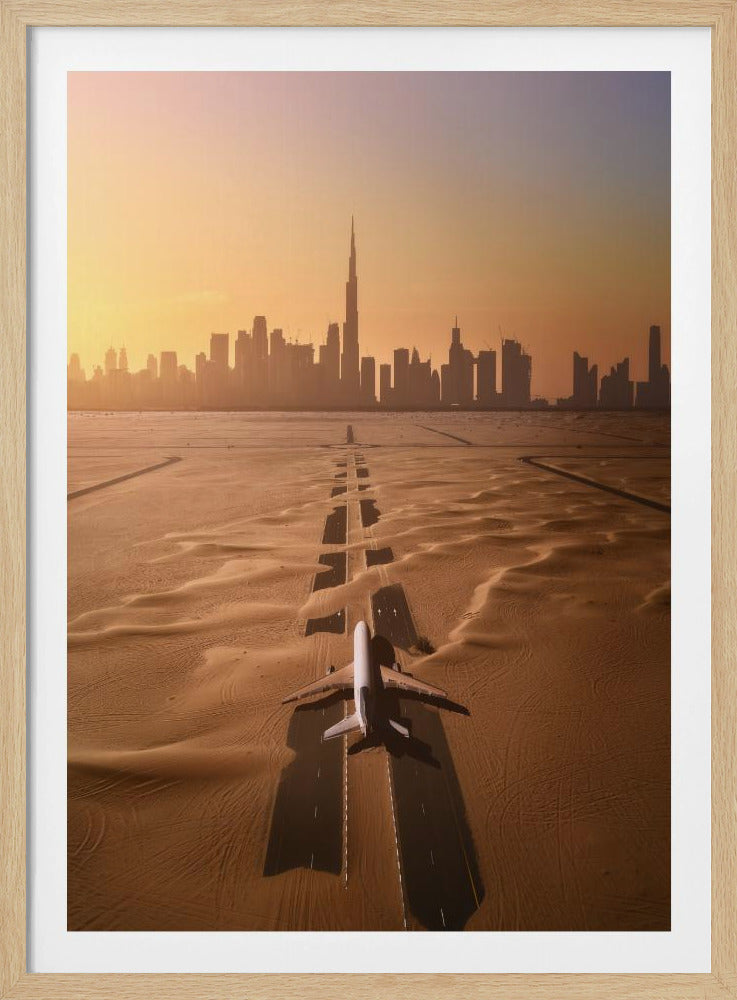 A surreal high-angle view of a white airplane on a runway partially buried in desert sand, pointing towards the Dubai city skyline during a hazy orange sunset. Decor