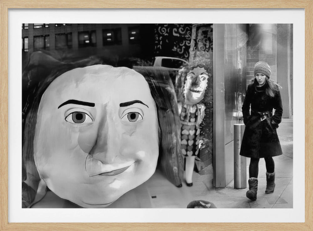 A surreal black and white photograph with a silver frame, featuring a giant, cartoonish head of a historical figure reflected in a window, juxtaposed with a young woman in a winter coat and beanie walking down a city sidewalk. Wall Art