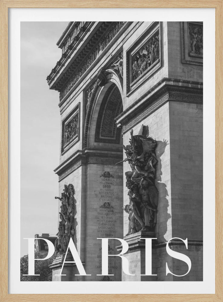A black and white close-up photograph of the Arc de Triomphe in Paris, framed in black. The image is shot from a low angle, highlighting the monument's grand architecture and detailed stone sculptures. The word 'PARIS' is printed in large white capital letters across the bottom. Artwork