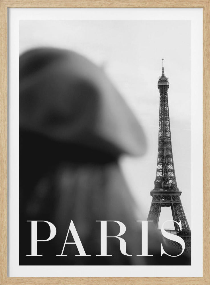 A black and white poster featuring the Eiffel Tower in sharp focus on the right side against a light gray sky. A heavily blurred dark shape, possibly a person, is in the foreground on the left. The word 'PARIS' is written in a large, white serif font at the bottom. Wall Art