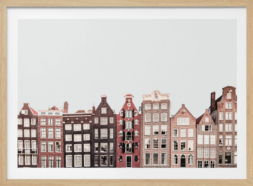 A framed, eye-level photograph of a row of colorful, traditional Dutch canal houses in Amsterdam, showcasing their varied gabled architecture against a minimalist white sky. Print