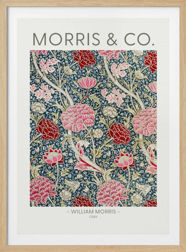 A framed art print of William Morris's 'Cray' pattern, featuring a dense floral design with large pink and red stylized flowers and foliage on a dark navy blue background. The text 'MORRIS & CO.' is above the pattern, and '- WILLIAM MORRIS - CRAY' is below. Artwork