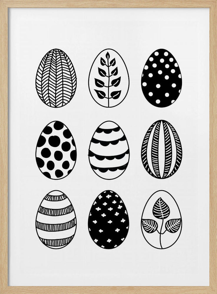 A black and white art print featuring a 3x3 grid of nine illustrated Easter eggs. Each egg has a unique, hand-drawn pattern, including polka dots, stripes, chevrons, florals, and leafy branches, all within a thin black frame. Poster