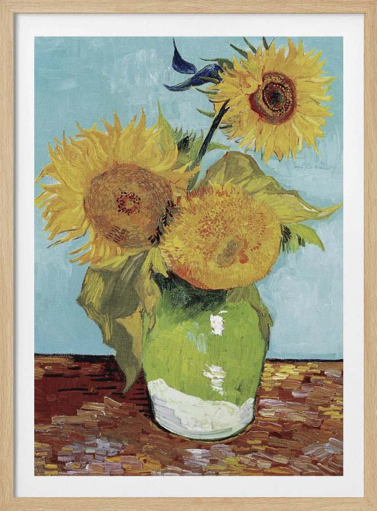 A framed reproduction of Vincent van Gogh's famous 'Sunflowers' painting, featuring three large yellow sunflowers in a green vase against a light blue background, painted in his iconic post-impressionist style with thick brushstrokes. Wall Art
